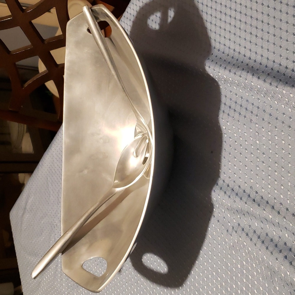 New salad bowl with serving utensils